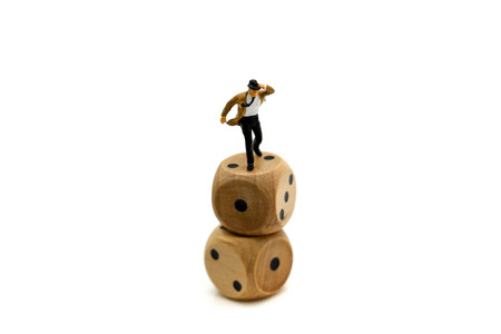 Miniature people : businessman standing on wooden dices,business Challenge concept.の写真素材