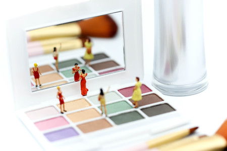 Miniature people : beautiful woman and friend with Makeup products with cosmetic beauty products.の写真素材