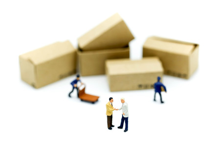 Miniature people : businessmen hand checking, standing in front of  Worker and box using as background shipping, rent container, business concept.の写真素材