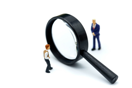 Miniature people : young businessman with magnifying glass of Successful businessman,Business Growth concept.の写真素材