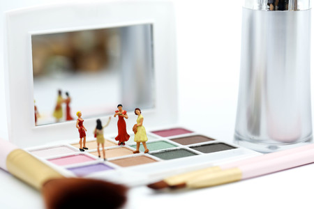 Miniature people : beautiful woman and friend with Makeup products with cosmetic beauty products.の写真素材