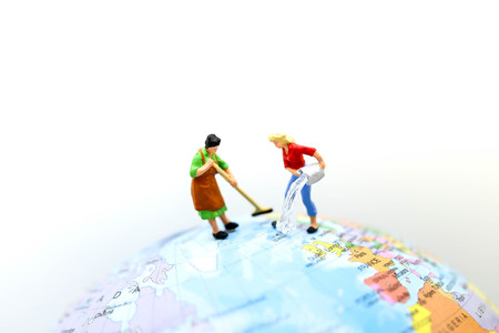 Miniature people : Maid or Housewife cleaning on mini world map.の写真素材