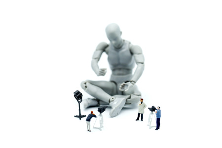 Miniature people : journalists , cameraman ,Videographer at work shooting on  Model robot action,production concept.の写真素材