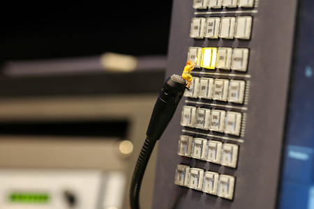 Miniature people : Maid or Housewife cleaning on Switcher buttons in studio TV station, Audio and...
