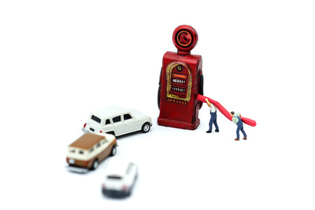 Miniature people : businessman and worker with gas station pump.の写真素材