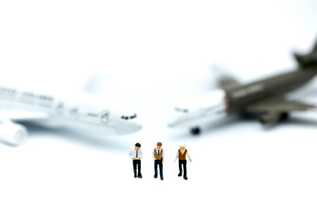 Miniature people : young business with  air plane using for business trip concept.の写真素材