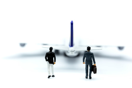 Miniature people : young business with air plane using for business trip concept.の写真素材