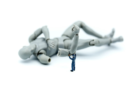 Miniature people : engineers working on electronics components and fixing broken robotの写真素材