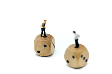 Miniature people : young businessman standing on dice,Gambling and casino business concept.の写真素材