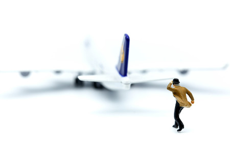 Miniature people : young business with air plane using for business trip concept.の写真素材