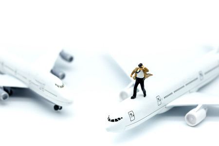 Miniature people : young business with air plane using for business trip concept.の写真素材