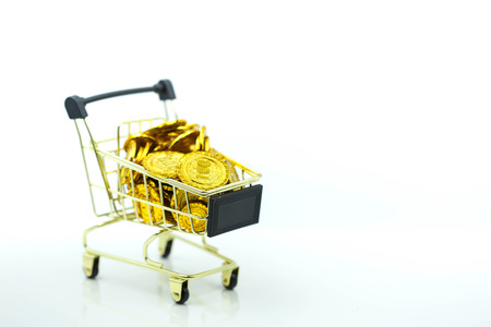 Shopping cart with gold coins  or supermarket trolley isolated on the white background, business money and market concept. investment idea.の写真素材