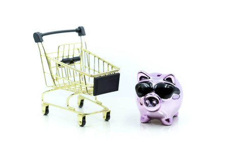 Purple Big piggy bank with shopping cart on   white background,Saving money concept.の写真素材