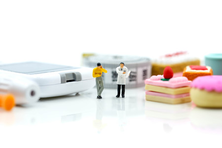 Miniature people : Doctor and patient with Glucose meter diabetes test  and Syringe with measuring tape,concept of diabetes, healthy lifestyles and nutritionの写真素材