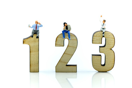 Miniature people : Businessman sitting on wooden number of 1,2,3,Business competition Concept.の写真素材