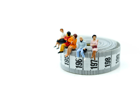 Miniature people : beautiful woman  with tape Measure,Healthcare and diet concept.