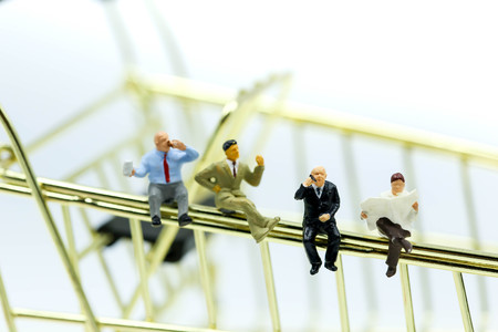 Miniature people : businessman sitting with shopping cart,Business shopping Concept.の写真素材