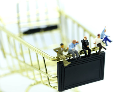 Miniature people : businessman sitting with shopping cart,Business shopping Concept.の写真素材