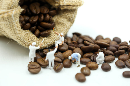 Miniature people : worker painting coffee beans,art, creativity and relax concept.の写真素材