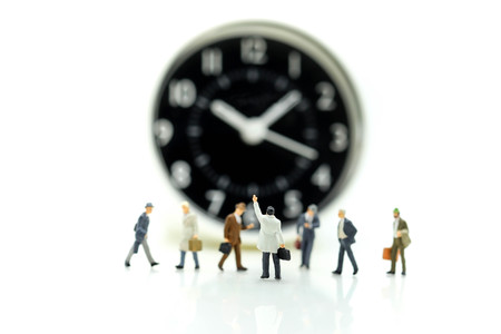 Miniature people : Businessman standing with Clock,Time business meeting concept.の写真素材