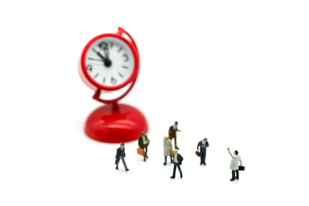 Miniature people : Businessman standing with Clock,Time business meeting concept.の写真素材