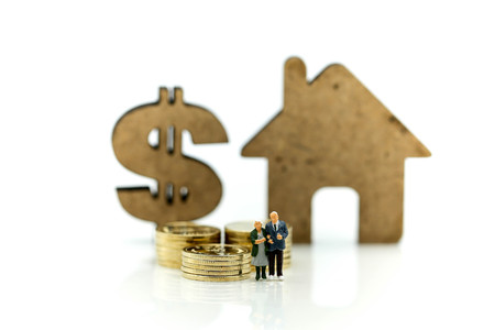 Miniature people : Couple of love with dollar sign,piggy bank,house, Saving to buy a house or home savings concept.の写真素材