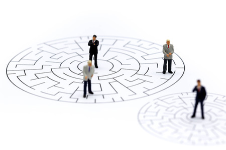 Miniature people: Businessman standing on start point of maze , business finding solution, problem solving and challenge concept.の写真素材