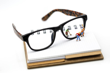 Miniature people : Maid or Housewife cleaning glasses on note book.の写真素材