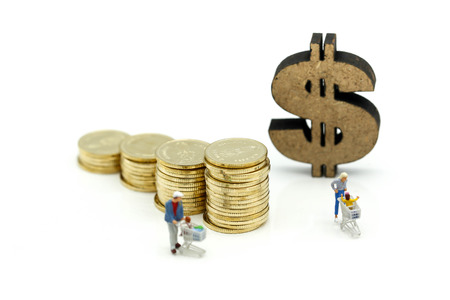 Miniature people : Family Mother, Father and children go shopping with stack of coins and dollar...