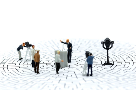 Miniature people : journalists , cameraman ,Videographer at work shooting of the campaign on mazeの写真素材