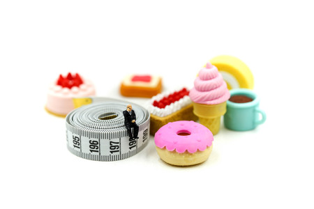 Miniature people : Doctor and patient with Glucose meter diabetes test and Syringe with measuring tape,concept of diabetes, healthy lifestyles and nutritionの写真素材