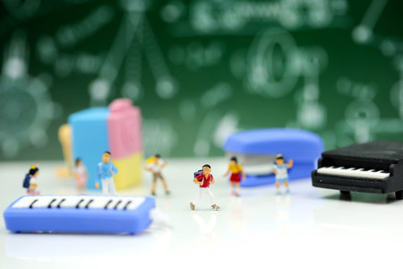Miniature people : Teacher and students , children with School supplies and piano , Back to school concept.の写真素材