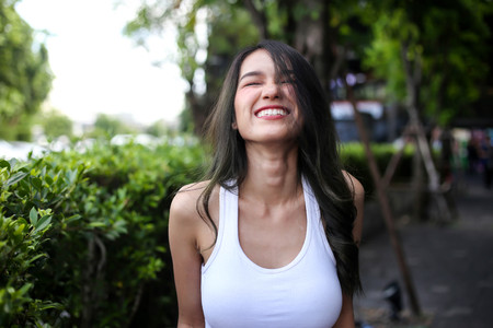 Pretty woman with natural beauty smiling at camera. Youth and happiness concept.の写真素材