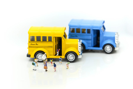 Miniature people : A group of young children getting on the schoolbus,schoolbus transportation...