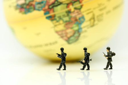 Miniature people : soldiers team with world map,War, army, military, guard concept.の写真素材