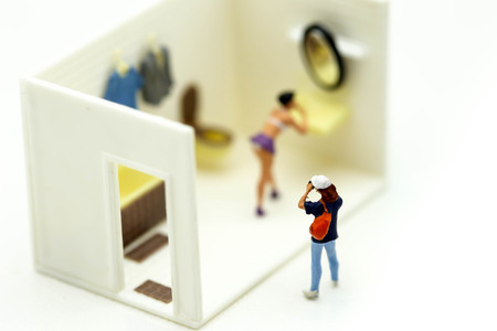 Miniature people : man is hiding behind  bathroom Spying. Voyeurism with woman  taking showerの写真素材
