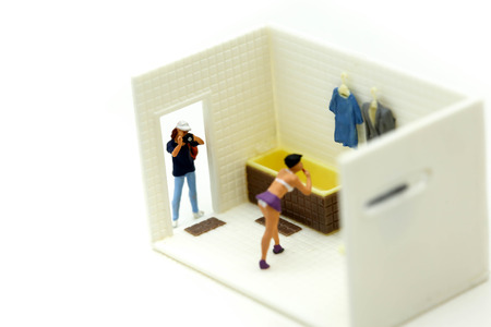 Miniature people : man is hiding behind  bathroom Spying. Voyeurism with woman  taking showerの写真素材