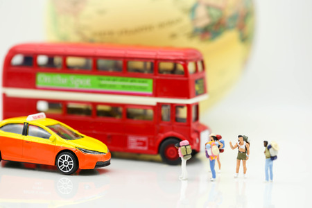Miniature people : Traveler backpacking Calling Taxi with tourist bus,Travel concept.の写真素材