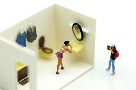 Miniature people : man is hiding behind  bathroom Spying. Voyeurism with woman  taking showerの写真素材