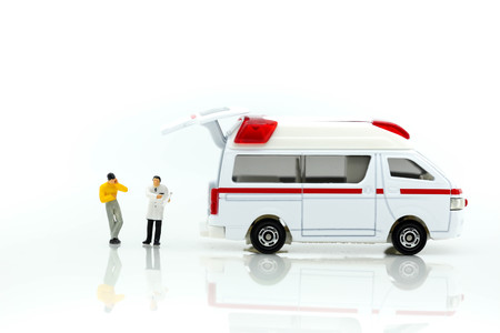 Miniature people : Doctor and Paramedic attending to patient in ambulance,Medicine ambulance conceptの写真素材