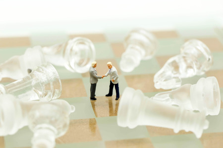 Chess business with miniature people : businessman  checking hand  idea for competition, success and leadership concept.の写真素材