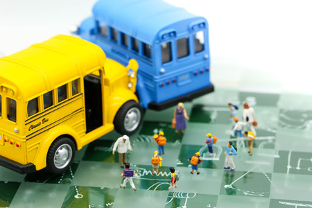 Miniature people : A group of young children getting on the schoolbus,schoolbus transportation educationの写真素材