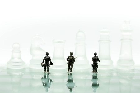 Miniature people : soldiers team with Chess business idea for competition, War, army, military, guard,business concept.の写真素材