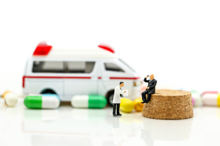 Miniature people : Doctor and Paramedic attending to patient in ambulance,Medicine ambulance conceptの写真素材