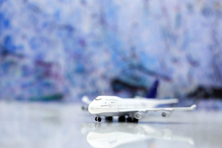 Miniature people : Traveler backpack with airplane,worldmap,luggage of snow winter background.