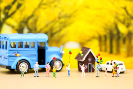 Miniature people : A group of young children getting on the schoolbus,schoolbus transportation educationの写真素材