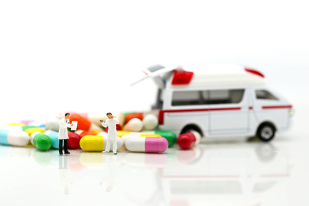 Miniature people : Doctor and Paramedic attending to patient in ambulance,Medicine ambulance conceptの写真素材