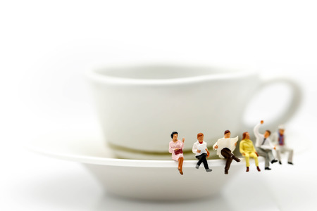 Miniature people : read a book and a newspaper on the cup of hot coffee and beans coffee,relaxing, hobby concept.の写真素材