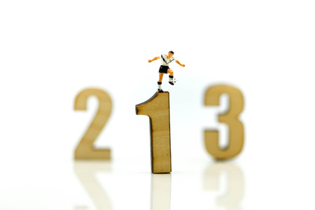 Miniature people : Soccer player man standing on wooden number of 1,2,3,football world championship...