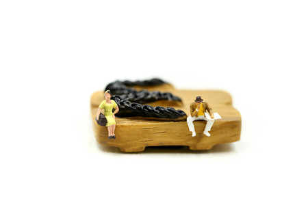 Miniature people : couple people sitting on Japanese wooden shoes (geta)